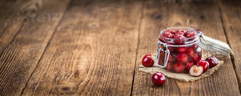 Fresh made Canned Cherries on a vintage background as detailed close-up shot