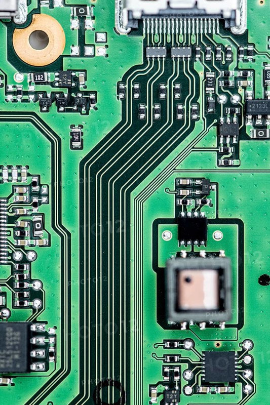 Green PCB (printed circuit board) close-up shot with a lot of electronic components