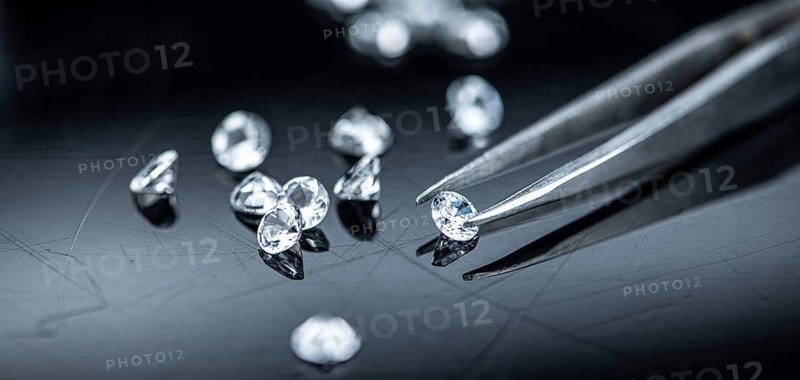 Small Diamonds on dark background as close up shot (selective focus)