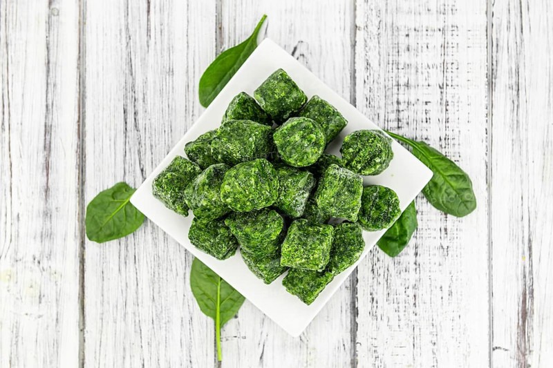 Frozen spinach cubes as detailed close up shot (selective focus)