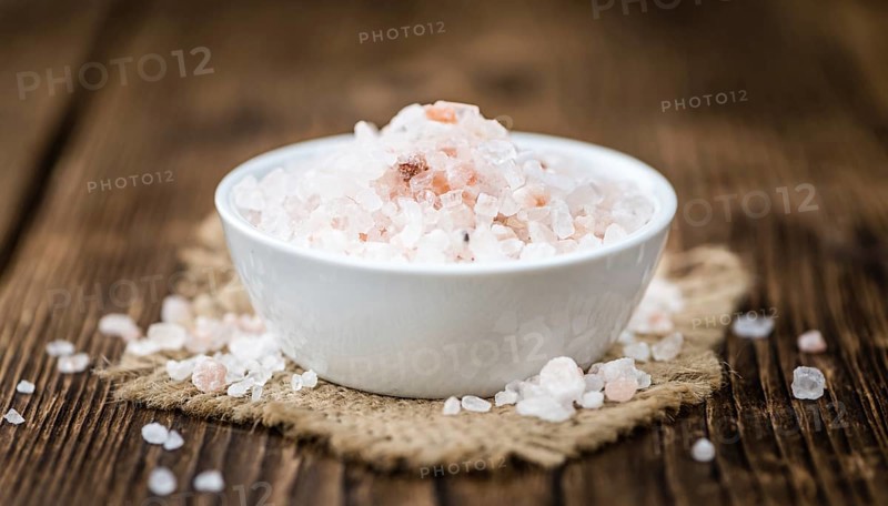 Pink Salt on a vintage background as detailed close-up shot (selective focus)
