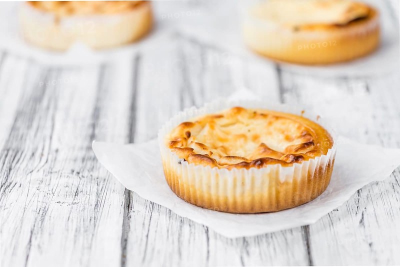 Fresh made Mini Cheesecake on a vintage background (close-up shot)
