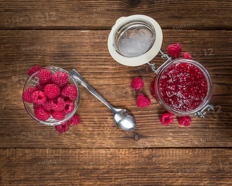 Fresh made Raspberry Jam on a vintage background as detailed close-up shot