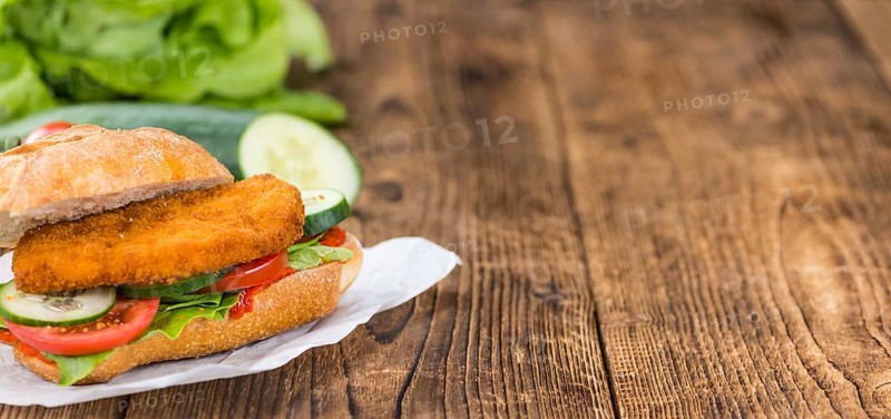 Fresh made Chicken Schnitzel on a bun (close-up shot, selective focus)