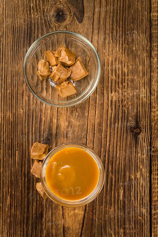 Portion of fresh Caramel Sauce (close-up shot, selective focus)