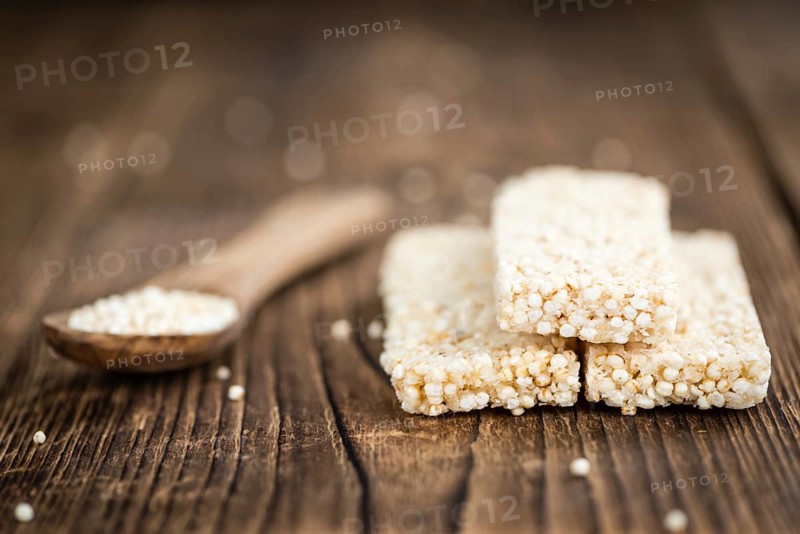 Fresh made Quinoa Bars (selective focus, close-up shot) on an old wooden table