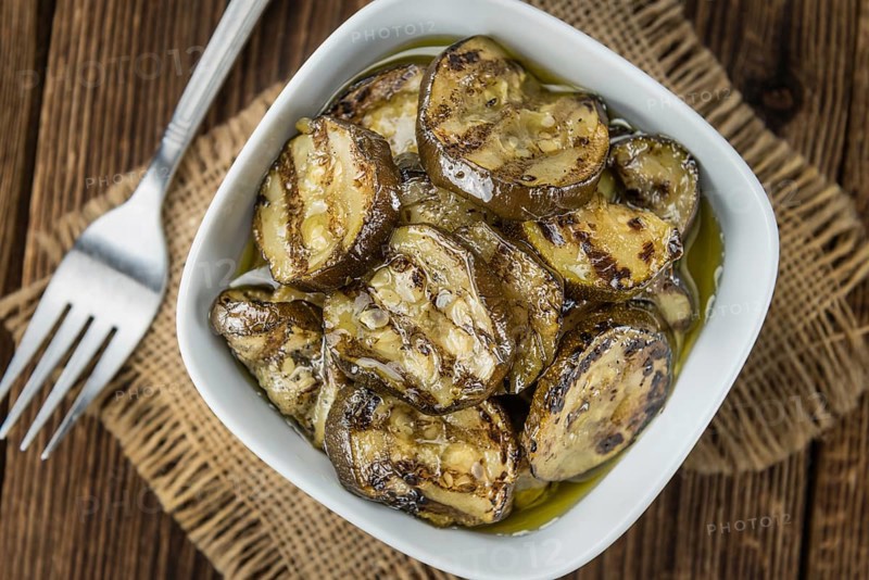 Fresh made Zucchinis (grilled) on an old and rustic wooden table (selective focus, close-up shot)
