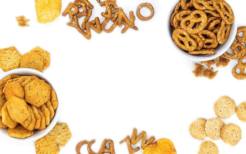 Portion of mixed Snacks isolated on white background (close up shot, selective focus)