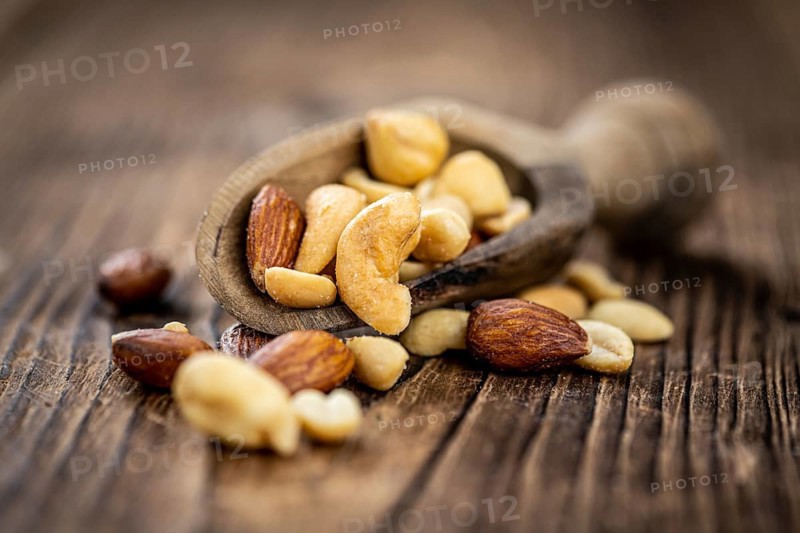 Roasted and salted nuts as detailed close up shot (selective focus)
