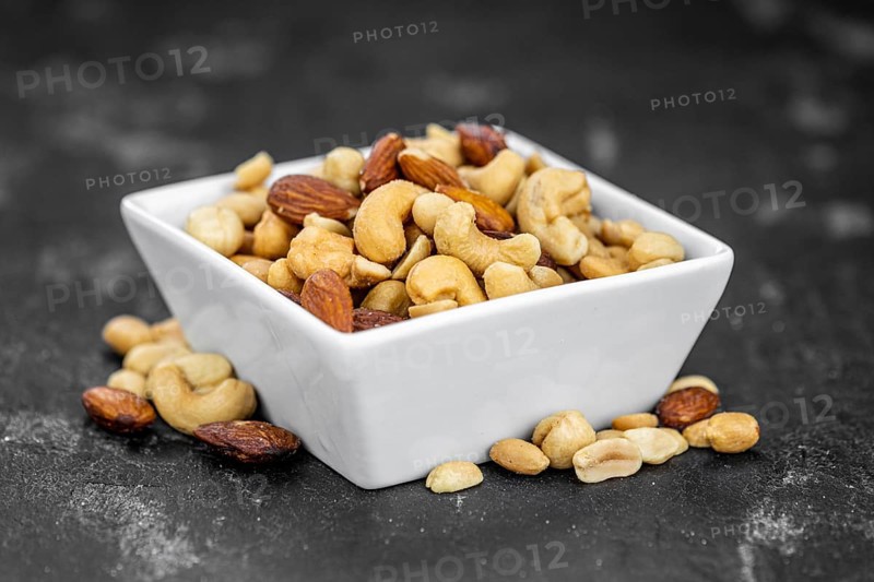Roasted and salted nuts as detailed close up shot (selective focus)