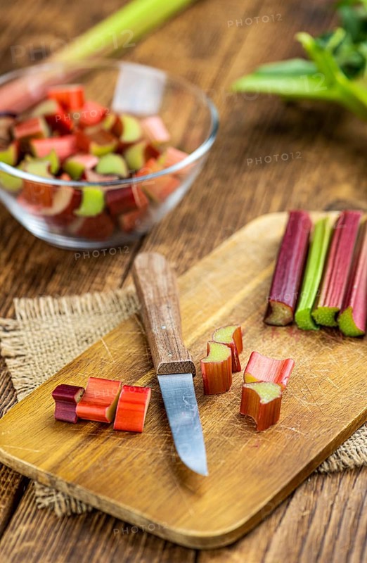 Chopped Rhubarb on an old wooden table (close up shot, selective focus)