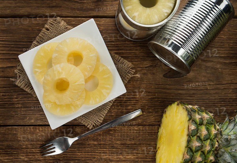 Preserved Pineapple Rings on a vintage background as detailed close-up shot, selective focus