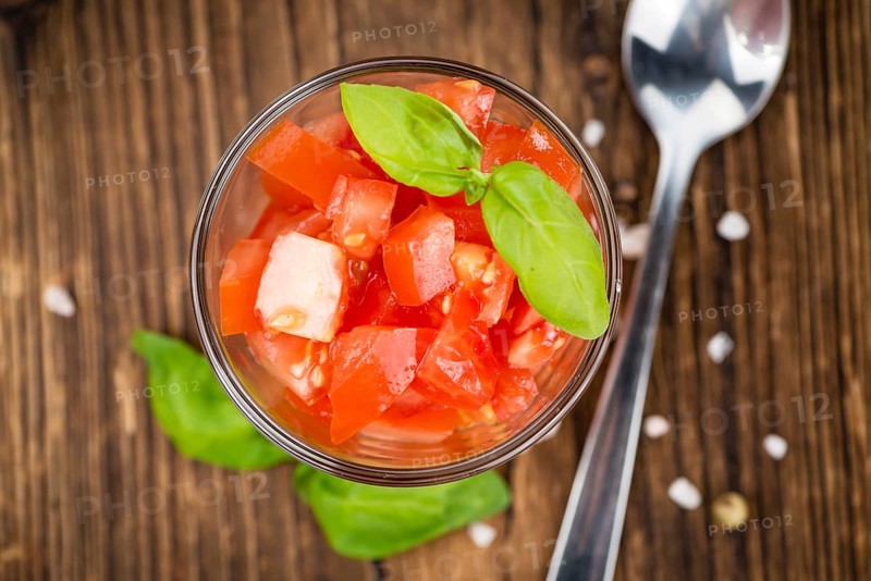 Diced Tomatoes on a vintage background as detailed close-up shot (selective focus)