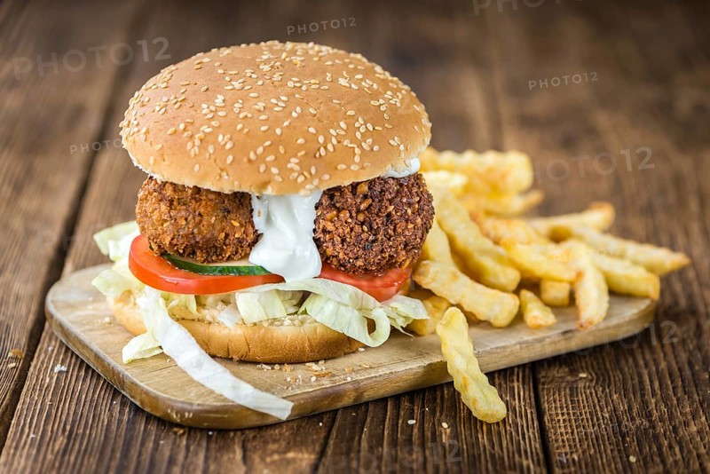 Homemade Falafel Burger (detailed close-up shot, selective focus) on a wooden table