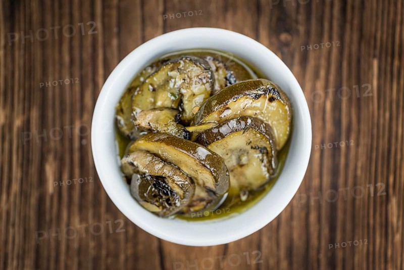 Zucchinis (grilled) as high detailed close-up shot on a vintage wooden table (selective focus)