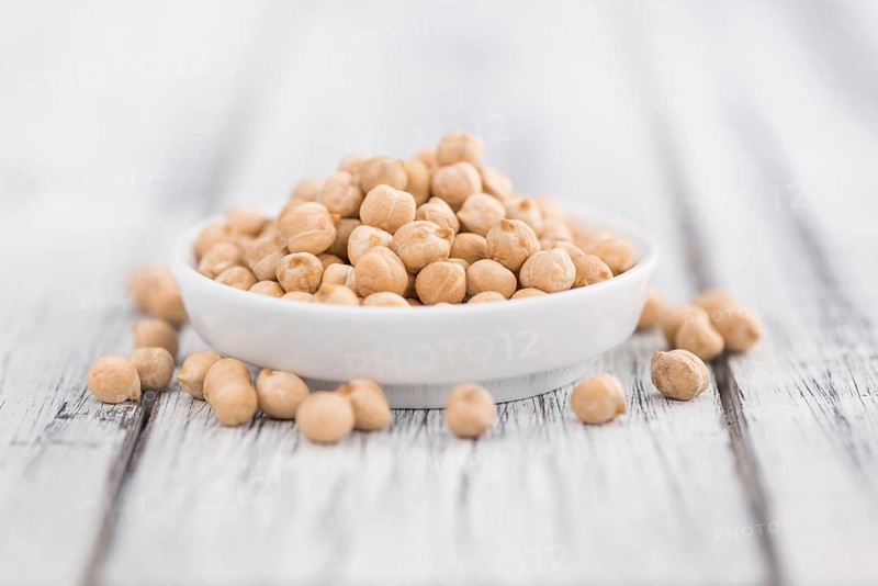 Chickpeas on a vintage background as detailed close-up shot, selective focus