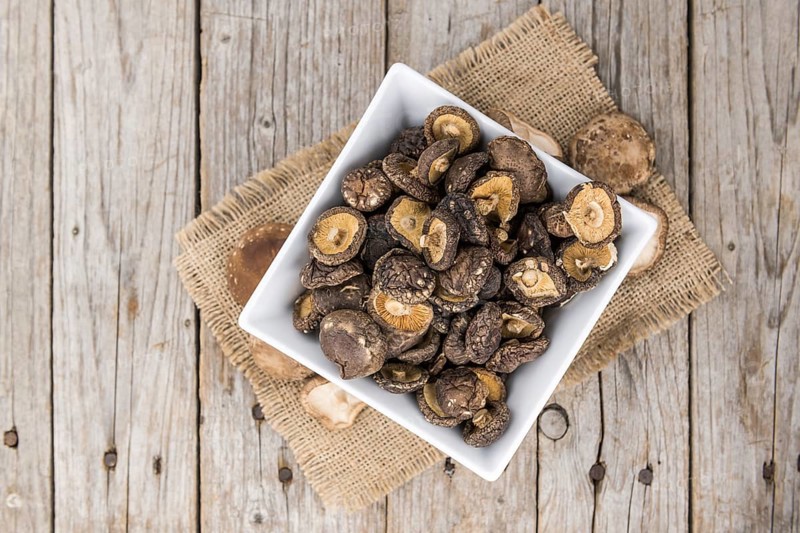 Dried Shiitake on a vintage background as detailed close-up shot, selective focus