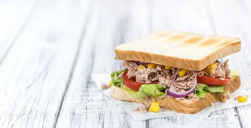 Homemade Tuna Sandwich (selective focus, close-up shot) on vintage wooden background