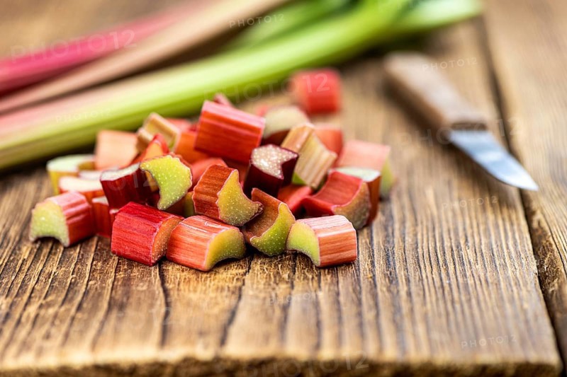 Chopped Rhubarb on an old wooden table (close up shot, selective focus)