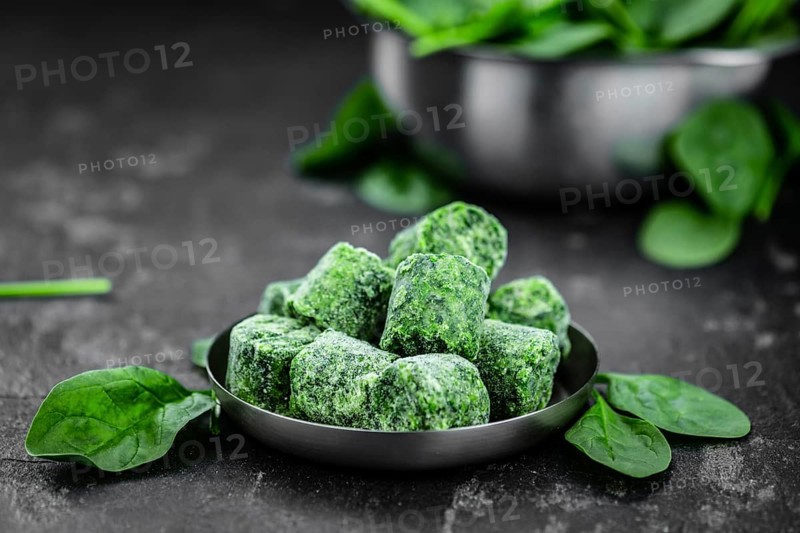 Frozen spinach cubes as detailed close up shot (selective focus)