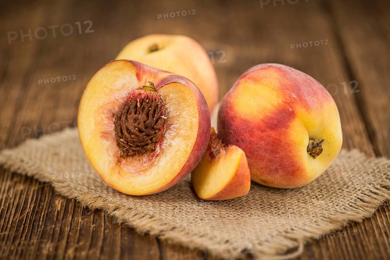 Peaches on a vintage background as detailed close-up shot, selective focus