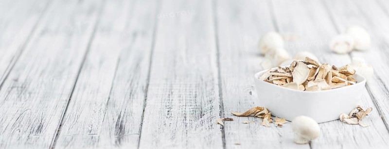Dried white Mushrooms on a vintage background as detailed close-up shot, selective focus