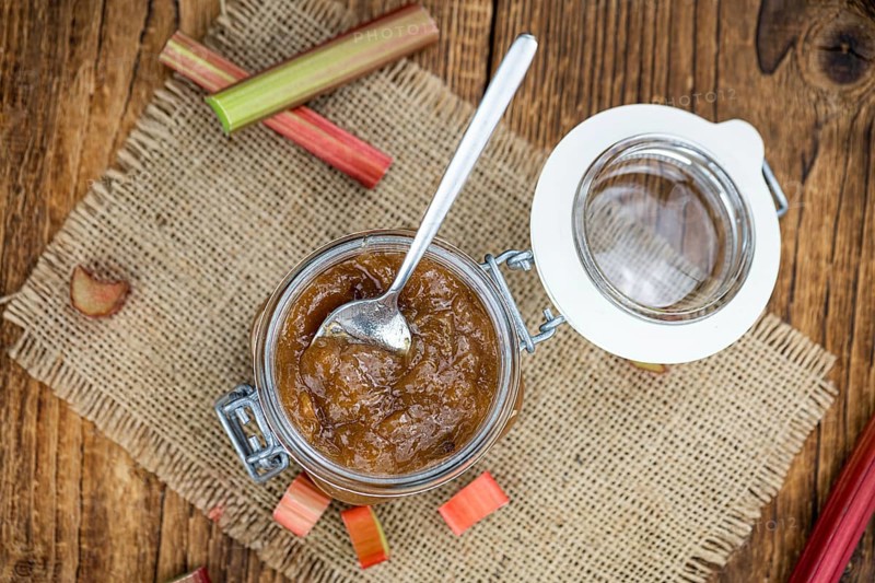 Rhubarb Jam on an old wooden table as detailed close up shot (selective focus)