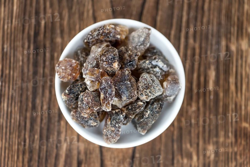 Brown Rock Candy on wooden background (selective focus, close-up shot)