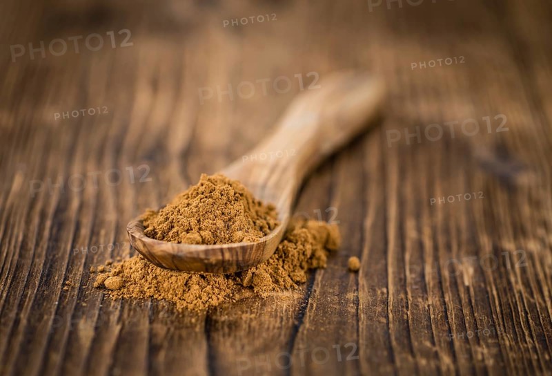 Fresh made Cinnamon Powder on a vintage background (close-up shot)