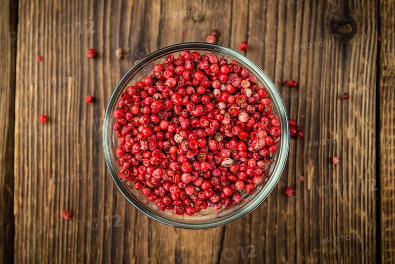 Pink Peppercorns on a vintage background as detailed close-up shot, selective focus