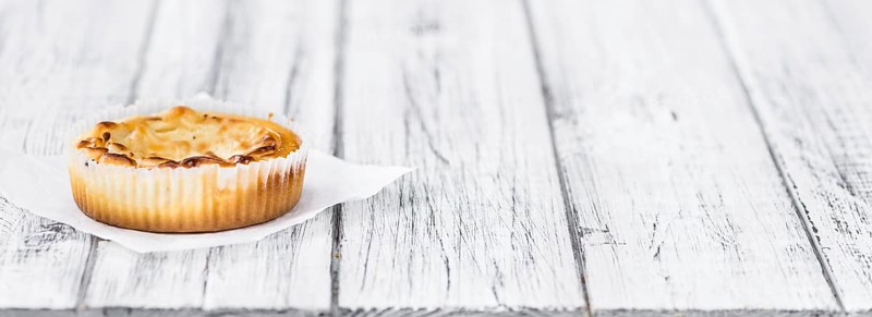 Fresh made Mini Cheesecake on an old and rustic wooden table (selective focus, close-up shot)