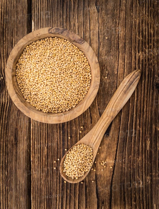 Seeds (Mustard) as high detailed close-up shot on a vintage wooden table (selective focus)