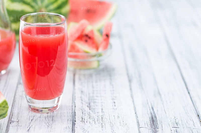 Homemade Watermelon Smoothie on an wooden table (selective focus) as detailed close-up shot