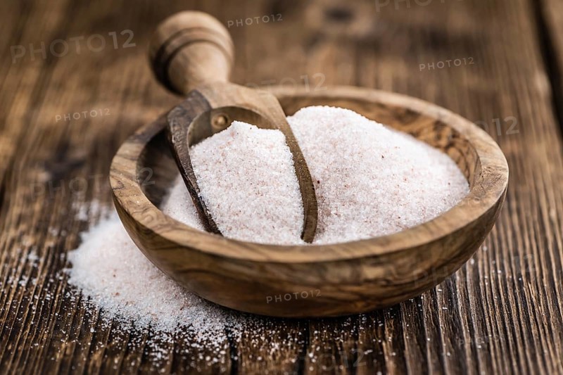 Pink Himalayan Salt on an old wooden table as detailed close-up shot (selective focus)