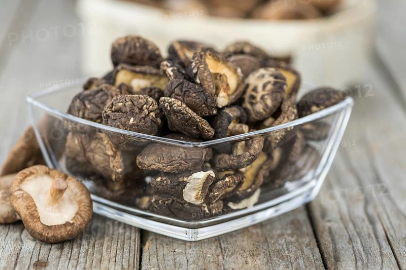 Homemade Dried Shiitake on an wooden table as detailed close-up shot, selective focus