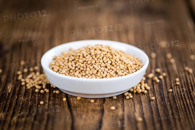 Mustard Seeds on a vintage background as detailed close-up shot (selective focus)