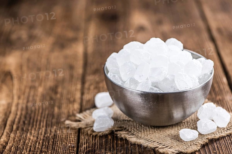 White Rock Candy on wooden background (detailed close-up shot, selective focus)