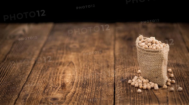 Chickpeas on a vintage background as detailed close-up shot, selective focus