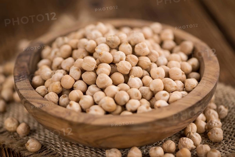 Chickpeas on an old wooden table as detailed close-up shot, selective focus
