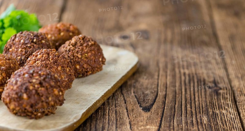 Portion of Falafel on an old wooden table (close-up shot, selective focus)