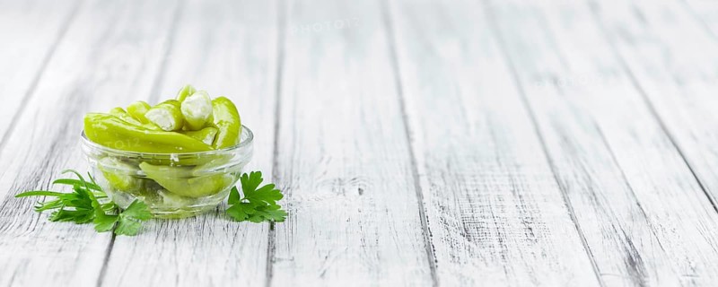 Fresh made Green Chilis (filled with cheese) on a vintage background (close-up shot)
