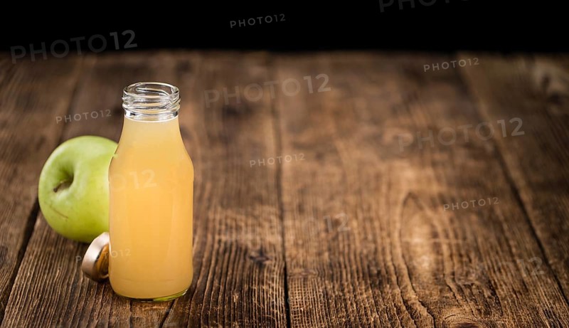 Fresh made Juice (apple) on a vintage background (close-up shot)