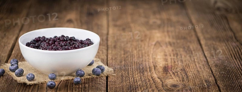 Homemade Preserved Blueberries on an wooden table as detailed close-up shot, selective focus