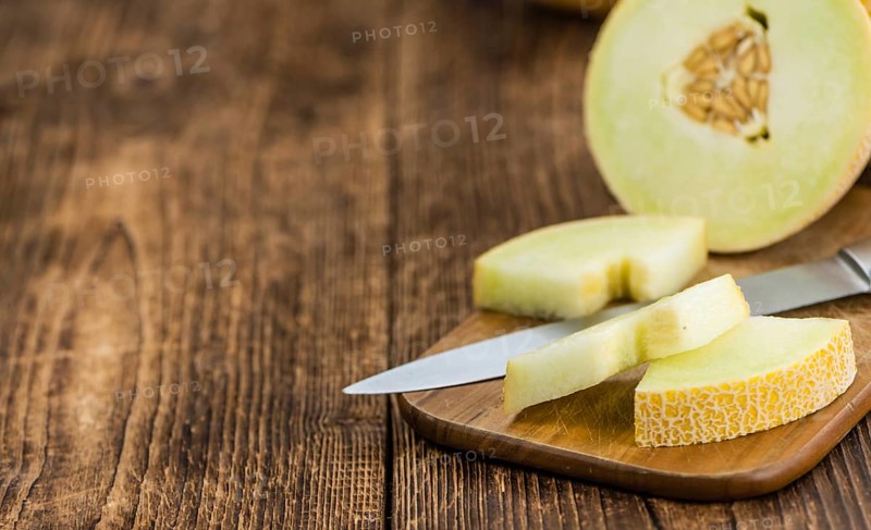 Fresh made Honeydew Melon on a vintage background (close-up shot)
