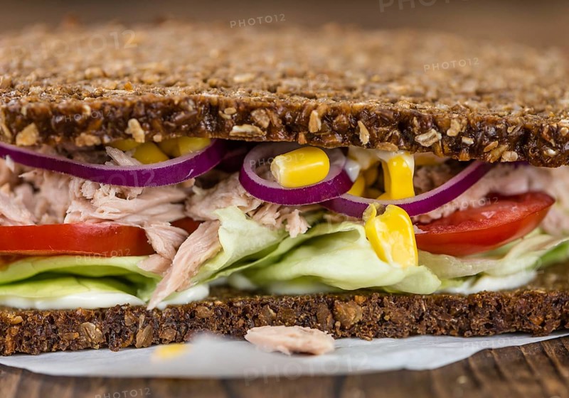 Old wooden table with Tuna sandwich (on wholemeal bread, selective focus)