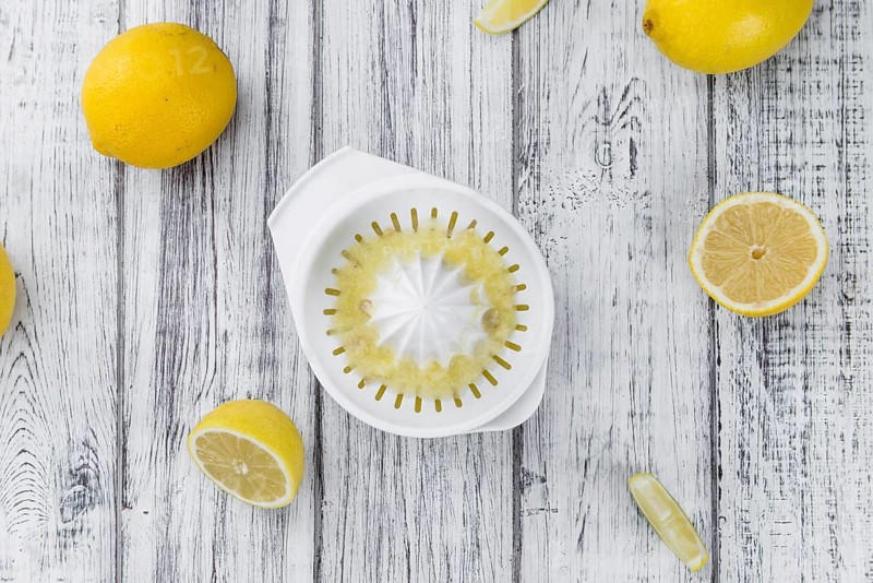 Homemade Lemon Juice on an wooden table (selective focus) as detailed close-up shot