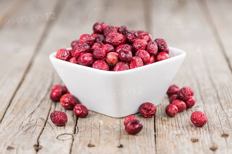 Dried Cranberries on an old wooden table (selective focus)