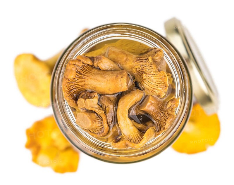 Portion of Canned chanterelles as detailed close-up shot isolated on white background