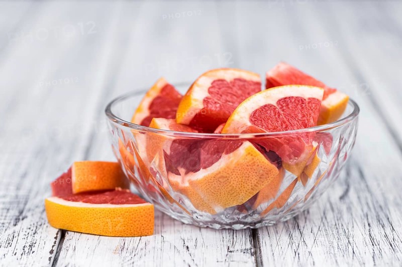 Grapefruits slices (selective focus) on a vintage background as detailed close-up shot