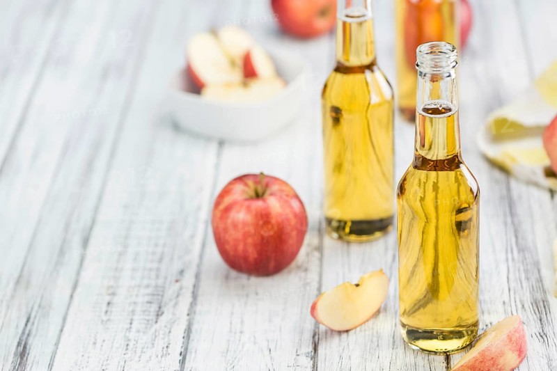 Fresh made Apple Cider on a vintage background (close-up shot)